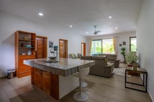 a kitchen and living room with a marble counter top at Pro Cab Apartment - Washer - BBQ in Cabarete