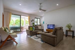 a living room with two couches and a tv at Pro Cab Apartment - Washer - BBQ in Cabarete