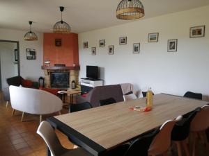 a dining room with a wooden table and chairs at Le clos des vaches in Usson-du-Poitou