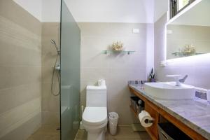 a bathroom with a sink and a toilet and a shower at Pro Cab Apartment - Washer - BBQ in Cabarete +36 photos