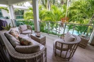 a porch with wicker chairs and a couch at Pro Cab Apartment - Washer - BBQ in Cabarete
