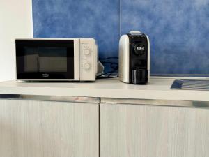 a microwave sitting on a counter next to a toaster at Aurora View Resort - Boutique Suites in Mascali