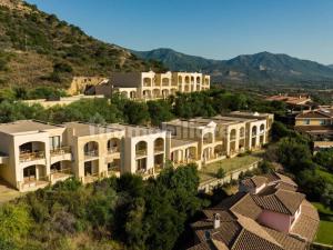 an aerial view of a building with mountains in the background at Is Molas Domus Michela in Is Molas 