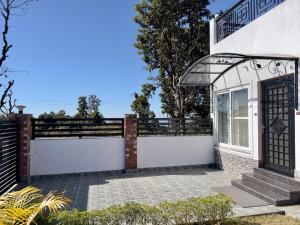 a gate to a house with a fence at Mananjay Natures Retreat in Jāmb +30 photos
