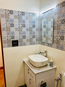 a bathroom with a sink and a mirror at Mananjay Natures Retreat in Jāmb