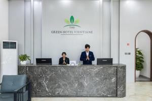 two people sitting at a counter with laptops at The Green Hotel Vientiane in Vientiane +80 photos