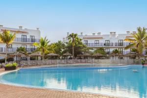 a large swimming pool in front of a hotel at SOL by Meliá Dunas Family Fun in Santa Maria