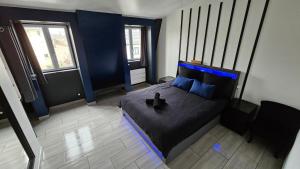 a bedroom with a bed with blue lights on it at Blue Duplex Proche Paris & Stade De France in Drancy