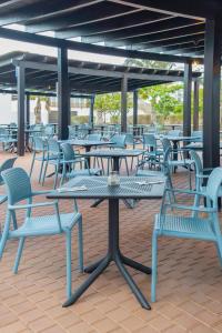 a group of tables and chairs on a patio at SOL by Meliá Dunas Family Fun in Santa Maria