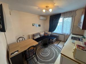 a small living room with a couch and a table at Berta Gardens 1 in Sandanski