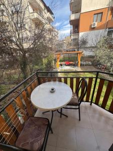 a table and chairs on a balcony with a fountain at Berta Gardens 1 in Sandanski