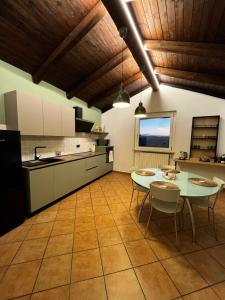a kitchen with a table and chairs in a room at Casa San Pietro centro storico in Castagnole Lanze