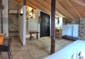 a room with a wooden floor and a black door at Casa rural Abatetxe in Elgóibar