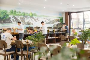 a group of people working in a restaurant at The Green Hotel Vientiane in Vientiane