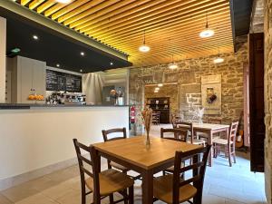 a restaurant with wooden tables and chairs and a counter at Palacio de Sansol in Sansol