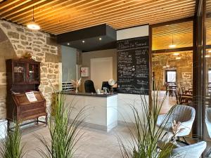 a restaurant with a counter with chairs and tables at Palacio de Sansol in Sansol