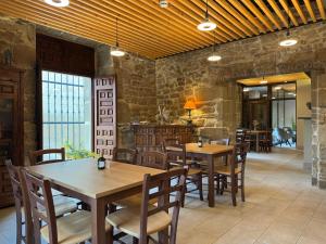 a dining room with wooden tables and chairs at Palacio de Sansol in Sansol