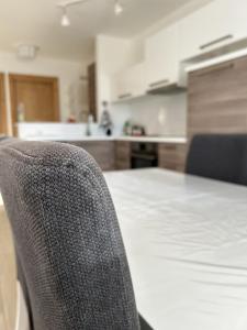 a kitchen with a table and a chair in a room at Bormio suite apartment, terme e sci a 5 min. di auto in Valdisotto