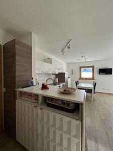 a kitchen with a sink and a counter top at Bormio suite apartment, terme e sci a 5 min. di auto in Valdisotto +25 photos