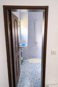 a bathroom with a shower and a toilet and a sink at Résidence Gnimakel in Abidjan +20 photos