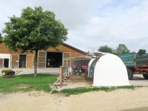 a white tent in front of a building at Ferienhof Windegg in Stockach +22 photos