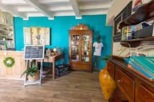a shop with a blue wall and a table in a room at La Matassina Tuscany in Castellina Marittima