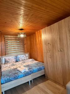 ein Schlafzimmer mit einem Bett und einer Holzdecke in der Unterkunft Vila Bon in Tetovo
