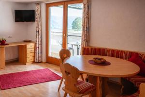 a dining room with a table and a window at A schön's Platzerl - Apartment Argus in Fügenberg