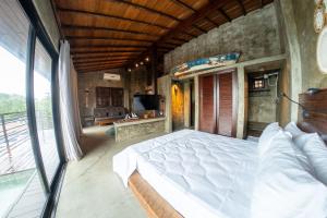 a bedroom with a large bed and a living room at Contemporary architecture by the sea in Búzios +28 photos