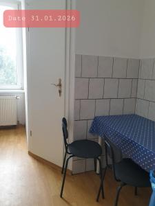 a table and chairs in a room with a blue table and chairs at Monteurwohnung bei Nina in Zeitz +7 photos