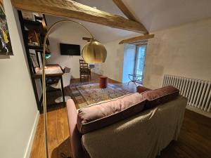 a living room with a couch and a table at Gîte de la petite touche in Seligny