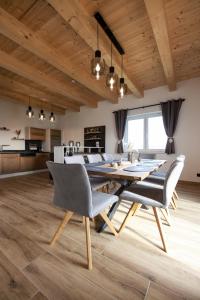 a dining room and kitchen with a table and chairs at Sonnendörfl in Poppendorf im Burgenland