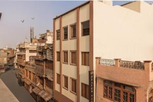 a tall white building next to a river at Hotel Heaven View - 50m From Golden Temple in Amritsar