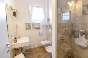 a bathroom with a toilet and a sink and a shower at La Matassina Tuscany in Castellina Marittima +31 photos