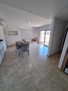 a living room with a table and a couch at Artigas 505 dpto 2 in Colón