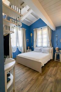 a bedroom with blue walls and a bed in a room at La Matassina Tuscany in Castellina Marittima