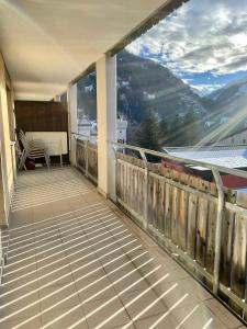 a balcony with a view of a mountain at Small bijoux Disentiserhof in Disentis +4 photos