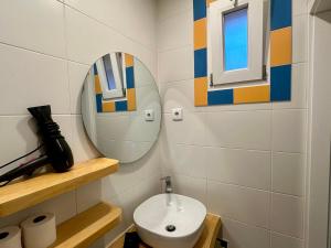 a bathroom with a sink and a mirror at Penedo Escape Retreat in Colares