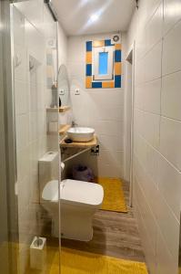 a bathroom with a toilet and a sink at Penedo Escape Retreat in Colares