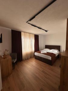 a hotel room with a bed and a window at Hotel Fortuna in Gradačac