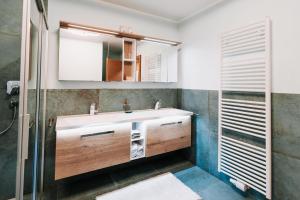 a bathroom with a sink and a mirror at App. Marlos in Leisach +27 photos