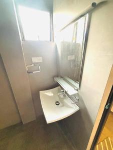 a bathroom with a white sink and a mirror at Ceylan Dream Hiriketiya in Nilwella +31 photos