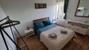 a bedroom with a bed with blue sheets and blue pillows at Émeraude in Voulême