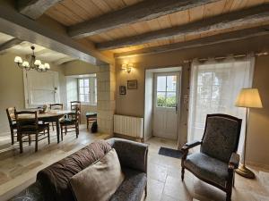 a living room with a couch and a table at Le logis in Mairé