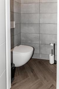 a bathroom with a white toilet in the corner at Slapen bij van O 2 in Yerseke +16 photos