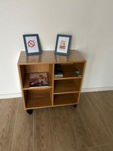 a wooden cabinet with two pictures on top of it at Paris visite in Ivry-sur-Seine