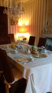a long table with a white table cloth on it at La pocterie in Vouneuil-sur-Vienne