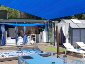 a blue tent on a deck next to a house at Spa Ibiza Dosrius - Bungalow con Jacuzzi y Piscina privada in Canyamás