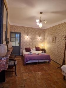 a bedroom with a large bed in a room at Logis Hotel - Restaurant La Marbrerie in Caunes-Minervois +52 photos
