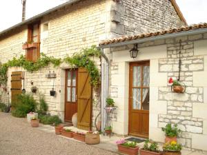 a brick building with potted plants on it at La cornouillère in Champau